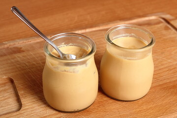 Milk pudding dessert in jar with spoon