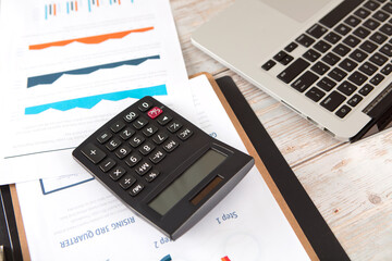 File calculator and laptop on the desk