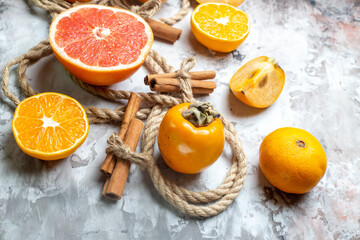 front view fresh persimmons with grapefruit on a light background fruit ripe citrus color photo health fresh