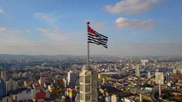 flight near flag and over buildings in the  city centre of Sao Paulo, 