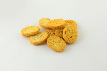 Stack of Italian black pepper and prosciutto ham flavored bread bites on white background
