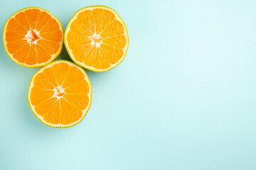 top view fresh tangerine slices on light-blue background photo color orange citrus fruit