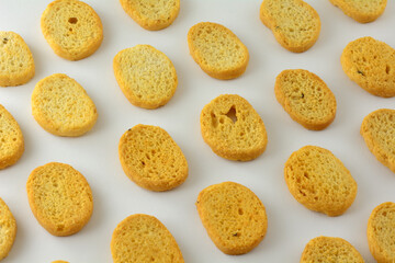 Italian black pepper and prosciutto ham flavored bread bites in a row on white background