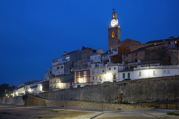 Ancient residential quarter and church with evening lights in Albaida