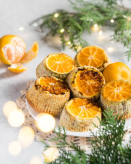 Homemade muffins with tangerines on the white plate on light grey background, selective focus, vertical orientation