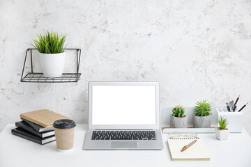 Interior of modern workplace with laptop