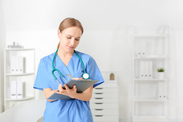 Beautiful young doctor working in clinic