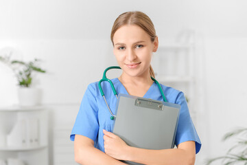 Beautiful young doctor working in clinic