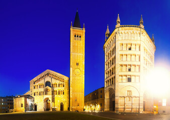 Naklejka premium Baptistery and Cathedral is religious landmark of night italian city Parma outdoors.