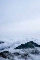 Dramatic view of Kiso Mountains engulfed in a sea of clouds in early autumn at Senjojiki Cirque in Nagano Prefecture, Japan.