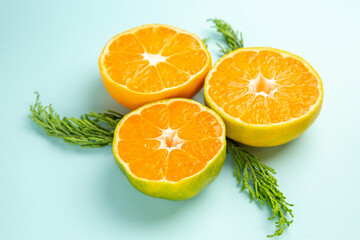front view fresh tangerine slices on light-blue background photo fruit color citrus orange