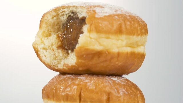 boiled condensed milk filled german Bismarck Donuts on white background