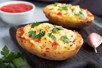 Baked potatoes in the peel stuffed with cheese with garlic and herbs.