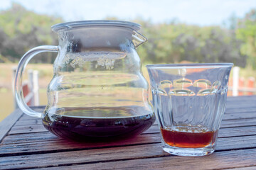 coffee maker mug and coffee cup in warm morning light.