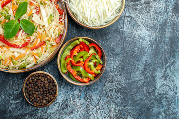 top view delicious vegetable salad with cabbage and bell-peppers on a grey background health lunch...