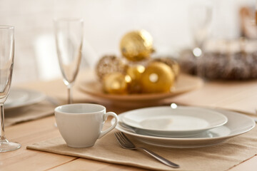 Christmas table setting with holiday decorations. New Year celebration.