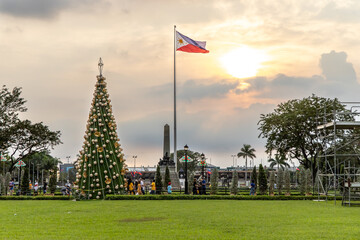 Rizal Park Christmas Tree and Philippine Flag Flying, Manila, Philippines, Dec 13, 2020
