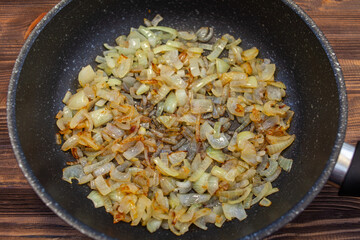 fried onions in a pan, top view.