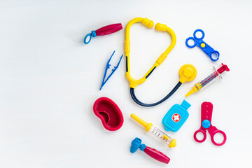 Children's medical instruments. Children's doctor concept. Pediatrics. Toy medical devices on a white background. Kids playing professional doctor. Choice of the profession. Get vaccinated Concept