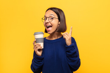 young latin woman feeling like a happy and excited genius after realizing an idea, cheerfully...