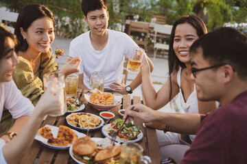 Group holiday party of asian people Eating dinner and drinking beer at home
