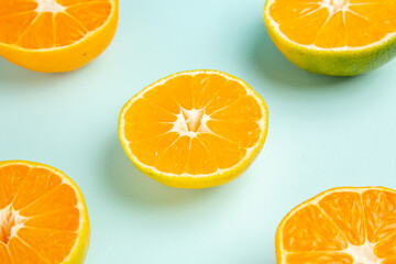front view fresh tangerine slices on light-blue background color fruit orange photo citrus...