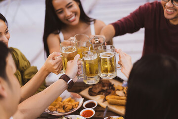 Group holiday party of asian people Eating dinner and drinking beer at home