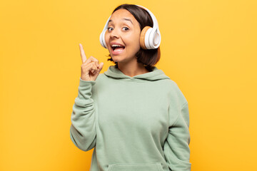 young latin woman feeling like a happy and excited genius after realizing an idea, cheerfully...