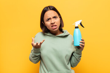 young latin woman looking angry, annoyed and frustrated screaming wtf or what’s wrong with you