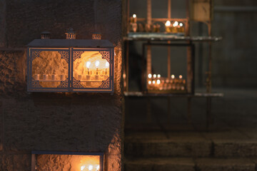 Many menorahs are lit at the entrance to an ancient house in the Jewish Quarter of the Old City, Jerusalem, Israel