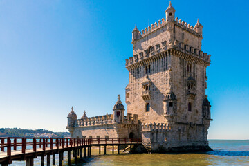 Scenic Belem Tower and wooden bridge miroring with low tides on Tagus River. Torre de Belem is Unesco Heritage and icon of Lisbon and the most visited attraction in Lisbon, Belem District, Portugal