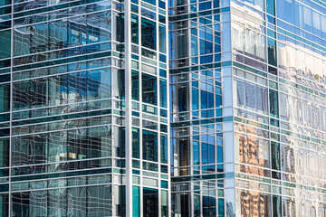 Plakat Office block glass wall reflecting sunlight in downtown