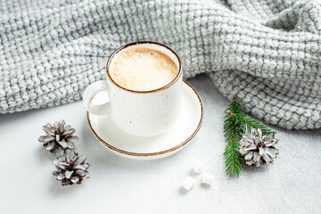 Winter composition in scandinavian style. White cup with coffee and marshmallow