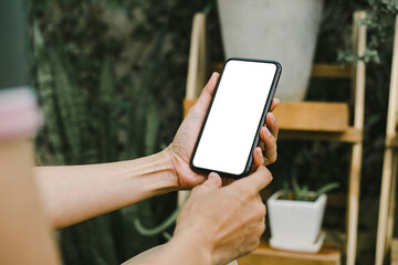 cell phone blank white screen mockup.woman hand holding texting using mobile on desk at cafe.background empty space for advertise.work people contact marketing business,technology