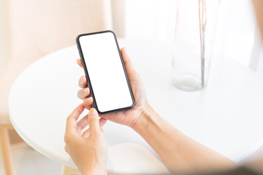 cell phone blank white screen mockup.woman hand holding texting using mobile on desk at office.background empty space for advertise.work people contact marketing business,technology