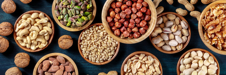 Nuts panorama. Many different nuts, shot from above on a dark background