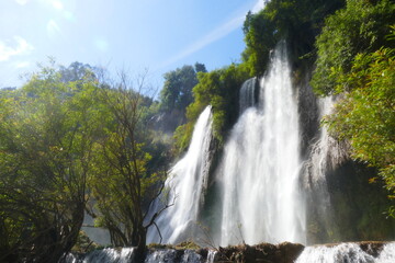 Fototapeta premium Photo picture of a fascinating view Thailand waterfall and the azure water with colors on the sun