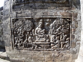 Stone carving on the wall of Mendut Temple, Central Java, Indonesia