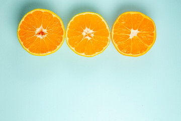 top view fresh tangerine slices lined on a light-blue background color orange photo juice fruit citrus