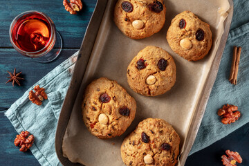 Vintage rock cookies, homemade biscuits with faces, shot from the top with a drink