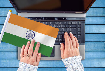 woman hands and flag of India on computer, laptop keyboard 