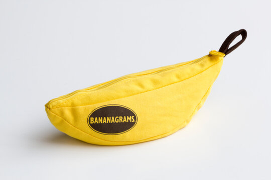 Portland, OR, USA - Apr 24, 2020: Bananagrams branded portable banana-shaped pouch isolated on a white background. Bananagrams is a word game wherein lettered tiles are used to spell words.