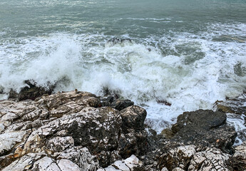 Splashing sea water, rocky coastline