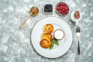 top view delicious muffins with berries on light background taste sugar sweet pancake dough fruit