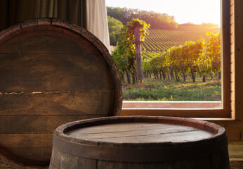 Glass of red wine standing on windowsill with autumn leaves and a fogged window in the background