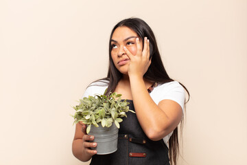 young latin woman feeling bored, frustrated and sleepy after a tiresome, dull and tedious task,...