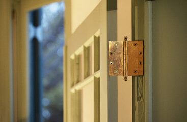 Hinge on the door at the entrance of the room