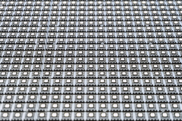 LED matrix outdoor screen close-up. Straight rows of LEDs on a modular panel. Limited depth of...