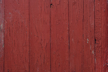 Cracked old red paint texture on a wooden boards surface