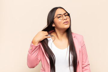 young latin woman feeling stressed, anxious, tired and frustrated, pulling shirt neck, looking...